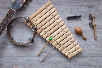 Pack of percussion instruments on a grey wooden table