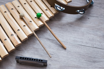 Pack of percussion instruments on a grey wooden table