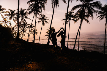 Silhouettes of beautiful couple on sunset. Sri Lanka