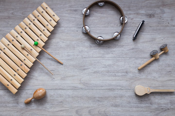 Pack of percussion instruments on a grey wooden table