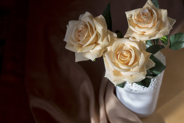 Roses tea color closeup. Beautiful bouquet of roses in a white vase.