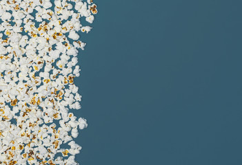 Popcorn isolated on blue background, microwave food