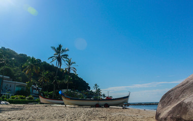 A boat on the beach sand. This photograph was taken in Matinhos,Paraná, Brazil, 2018.