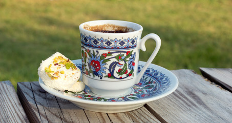 Cup hot black Turkish coffee and traditional sweets.