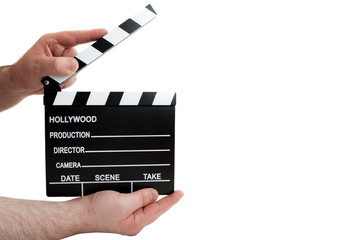 Hollywood movie production and vintage cinematography concept with a man holding a clapboard and...