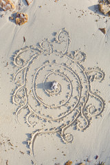 beautiful flower drawn into sand on a beach in thailand