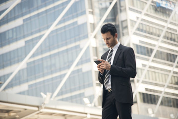 Fototapeta premium Handsome businessman using mobile phone. concept communication.
