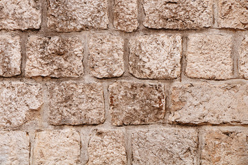 The texture of the stones and cobblestones. Fragment of the old fortress wall.