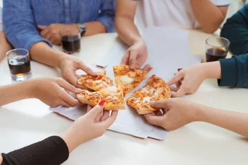 Schilderijen op glas People eat fast food. Friends hands taking slices of pizza © makistock