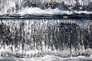 Fototapeta na wymiar Water fountain with cascade and backlight