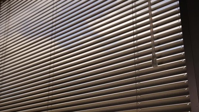 Close Up of venetian blinds dropping down slowly