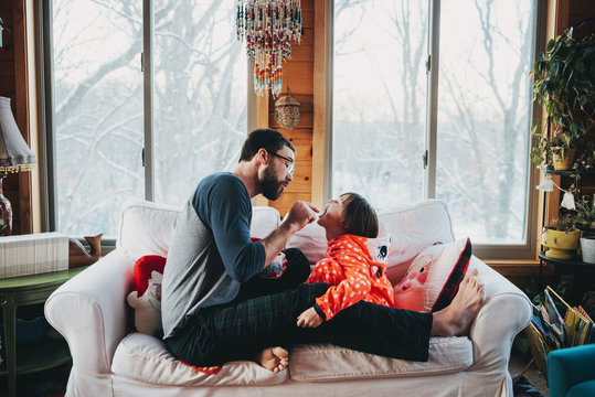 Father checking his daughter's teeth