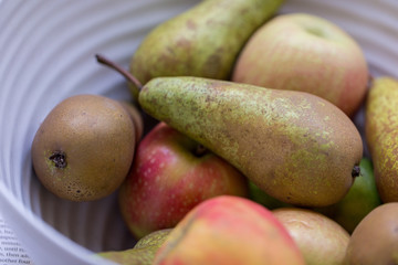 A fruit bowl with apples, pears and kiwi fruits