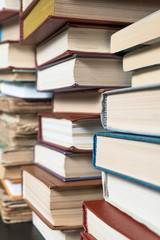 Many books in a bookstore or library on wooden background with copy space