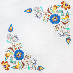 Fototapeta na wymiar embroidered flowers on a white background, handmade