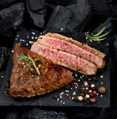 juicy grilled steak on a black slate.