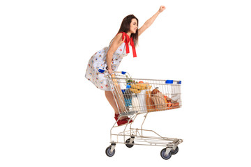 Woman with shopping cart full with products isolated over white background