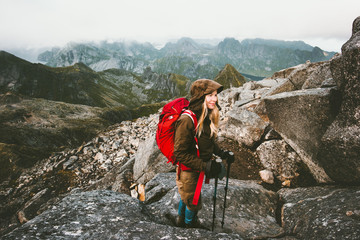 Traveler woman with backpack on Hermannsdalstinden mountain summit in Norway Travel Lifestyle wanderlust concept adventure active vacations outdoor hiking Lofoten islands