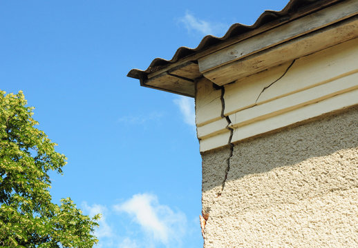 House Roof Wall Corner Crack. Close Up On Home Cracked Wall.