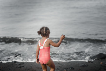 Happy girl jumping on the beach on the dawn time