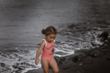Happy girl jumping on the beach on the dawn time