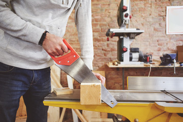 The young carpenter works in a workshop