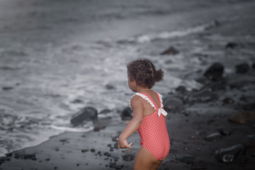 Happy girl jumping on the beach on the dawn time