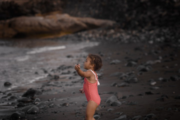 Happy girl jumping on the beach on the dawn time