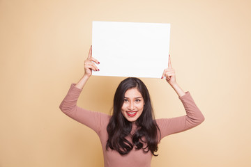Young Asian woman with white blank sign.