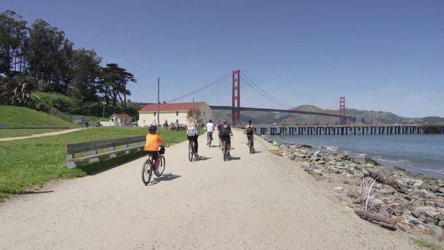 Riding bikes on an alley towards Golden Gate
