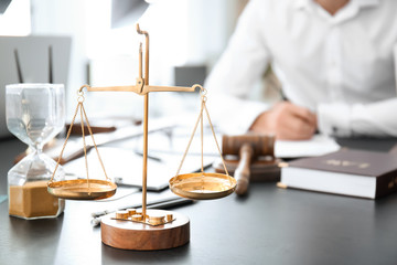 Scales of justice on table in lawyer's office