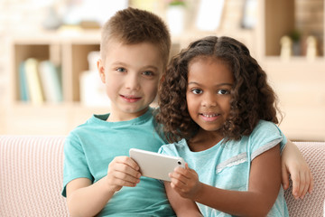 Cute children with smartphone indoors. Child adoption