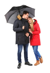 Young romantic couple with umbrella on white background