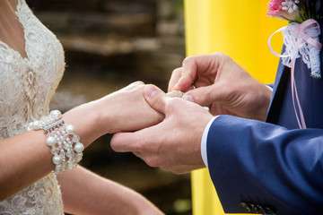 groom dresses the bride's ring at the wedding ceremony