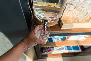 A girl is pouring the glass of water,Drink Water. Woman's Hand Pouring Fresh Pure Water From Pitcher Into A Glass. Health And Diet Concept. Healthy Lifestyle. Healthcare And Beauty. Hydratation.