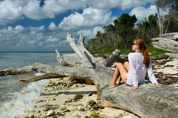 Relaxing tourist on the beach on Dominican Republic. Coast of the Del Este national park close the capital city Santo Domingo