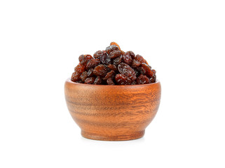 Black raisin on wood bowl isolated on white background