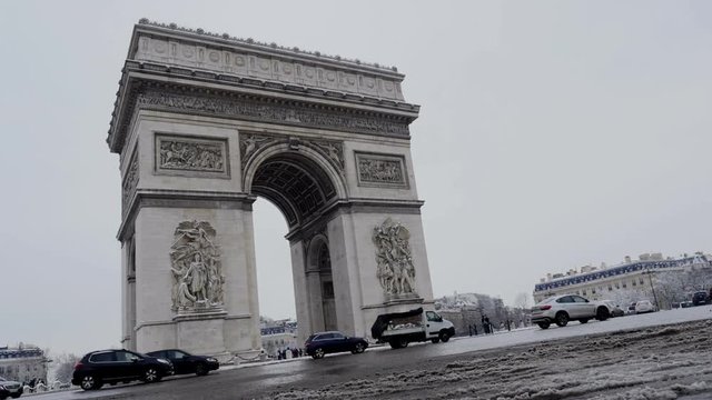 The arc de triumph by a rare snowy day in Paris, France