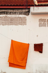 Yellow robe of Buddhist monk hanging on the  wall
