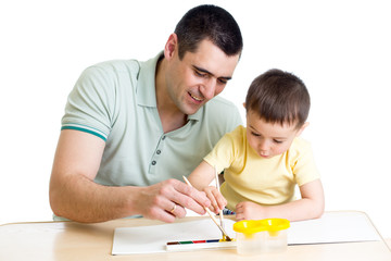 Father and kid son playing with paint colors