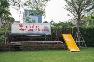 Playground with yellow slider and White fabric label