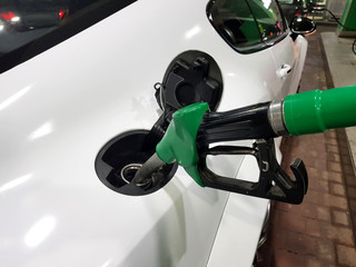 refueling gun in the tank at the gas station.