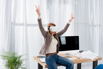 businesswoman in virtual reality headset at workplace in office