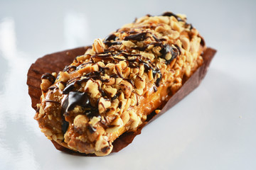 Nut bar with  with melted chocolate drizzled over the top. Energy bar. Sweet and tasty dessert.