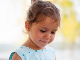 portrait of a 3 year old girl in summer clothing