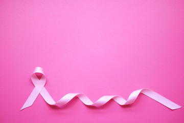 Pink ribbon on pink background, Symbol of breast cancer in women, Health care concept