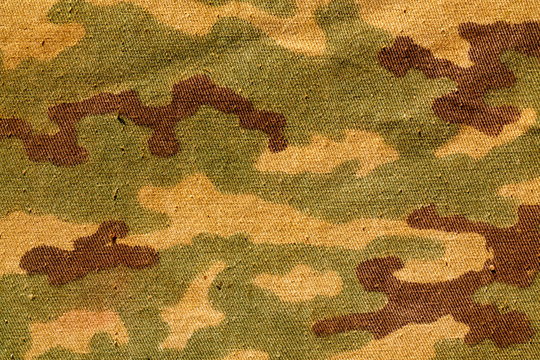Weathered camouflage textile cloth.