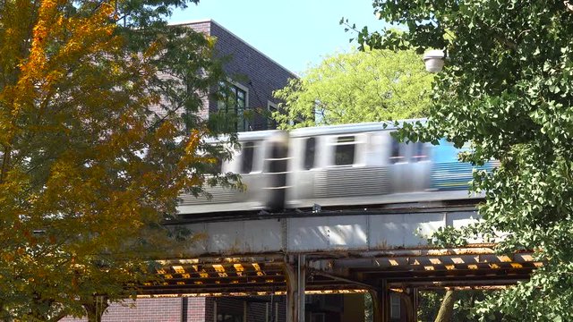 Establishing shot of a neighborhood in downtown Chicago wil El train passing.