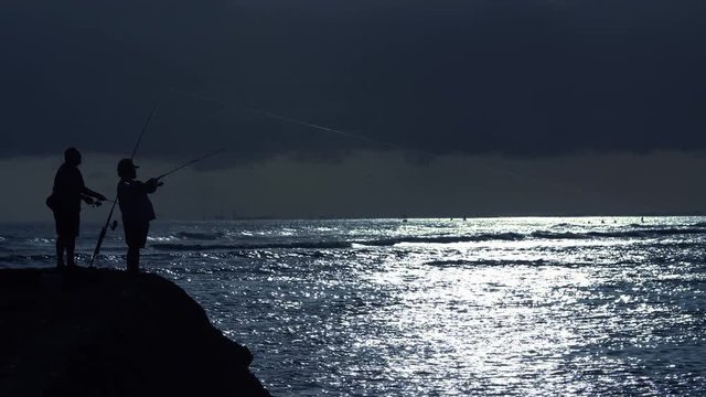 Fishermen Cast At A Cool Blue Sunset At Ala Moana Beach Park In Honolulu, Hawaii