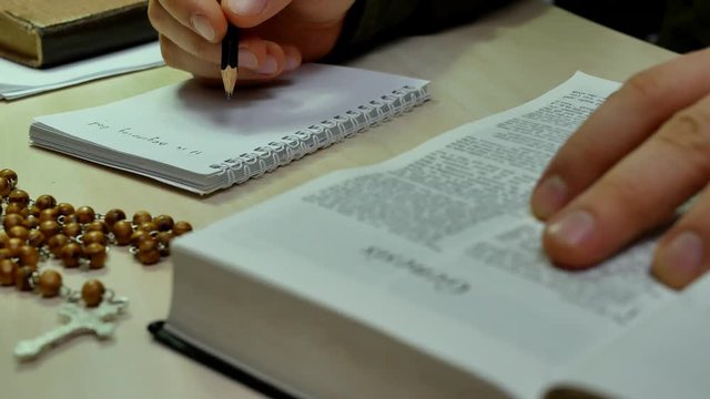 Holy Bible study and reading in church. Bible on the table with wooden rosary with cross